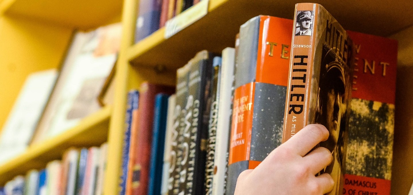 hand reaching for book about hitler