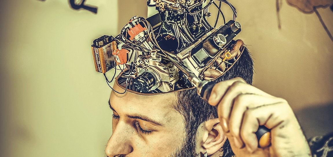 man fixing mechanical brain